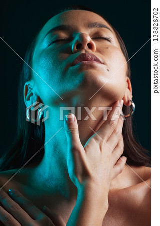 Neon, beauty and face of studio woman with natural cosmetics, artistic creativity or feeling soft skincare glow. Creative lighting, sensual shadow or relax person with makeup shine on dark background 138828702