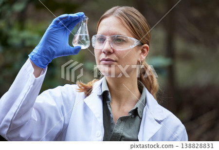 Water, research and woman scientist test in a forest for inspection of the ecosystem, sample or environment study. Science, sustainable and professional environmentalist doing carbon footprint exam Water, research and woman scientist test in a forest for inspection of the ecosystem, sample or environment study. Science, sustainable and professional environmentalist doing carbon footprint exam 138828831