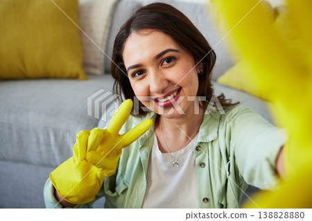 Woman, selfie and peace for cleaning home, portrait or smile in gloves, social media or sign language. Happy influencer girl, photography and profile picture with emoji to stop bacteria in apartment Woman, selfie and peace for cleaning home, portrait or smile in gloves, social media or sign language. Happy influencer girl, photography and profile picture with emoji to stop bacteria in apartment 138828880