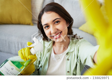 Woman, selfie and spray for cleaning home, portrait or smile in gloves, social media and chemical. Happy influencer girl, photography and profile picture with product to stop bacteria in living room Woman, selfie and spray for cleaning home, portrait or smile in gloves, social media and chemical. Happy influencer girl, photography and profile picture with product to stop bacteria in living room 138828971