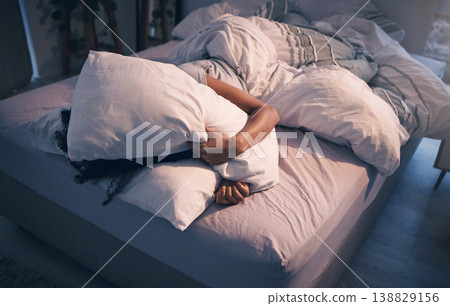 Stress, insomnia and woman with pillow on face, tired and frustrated with sleep, nightmare or dream. Fatigue, sleeping problem and exhausted girl in bed with fear, scared at night and crisis in home. 138829156