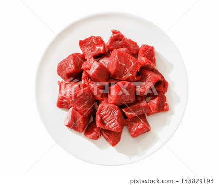 Raw beef meat cubes on white plate top view Raw beef meat cubes on white plate top view 138829193