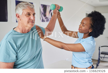 Senior man, physiotherapy and dumbbells with black woman for help in clinic workout for wellness. Nurse, physical therapist, patient and support with equipment for rehabilitation in nursing home. Senior man, physiotherapy and dumbbells with black woman for help in clinic workout for wellness. Nurse, physical therapist, patient and support with equipment for rehabilitation in nursing home. 138829326