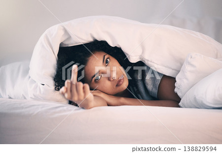 Angry, woman with insomnia and portrait in bed with a middle finger for morning or waking up, sleeping in bedroom or at home. Hand, show a curse sign and frustrated with sleep problem at night 138829594