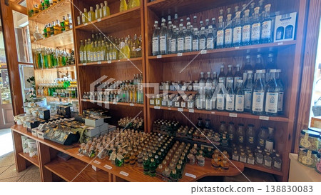 Local liquor bottles are beautifully displayed on wooden shelves and tables Local liquor bottles are beautifully displayed on wooden shelves and tables 138830083