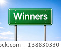 Green road sign with winners text isolated on blue sky background 138830330
