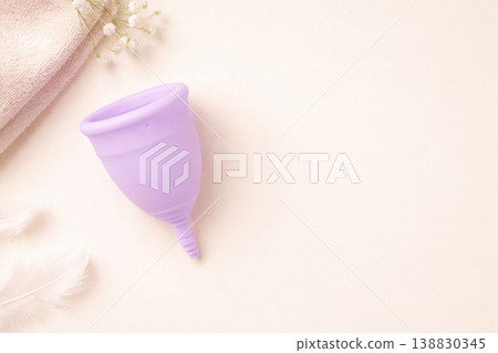 Purple menstrual cup on soft pastel background feminine hygiene concept Purple menstrual cup on soft pastel background feminine hygiene concept 138830345