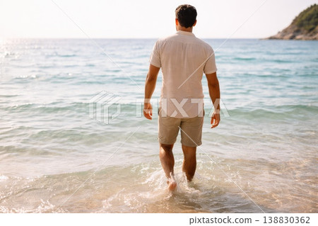 Man Walking into Sea Water at Sunny Beach Vacation 138830362