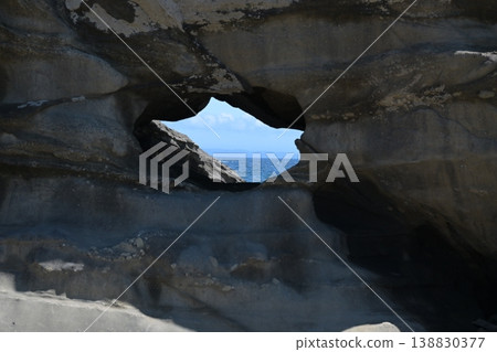The blue sea visible through the rocky window The blue sea visible through the rocky window 138830377