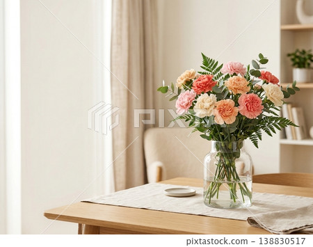 A living room table adorned with a bouquet of carnations; an interior bathed in soft light. 138830517
