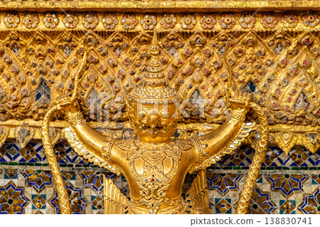 Tiny mirror pieces and gold surfaces show careful exterior work from the Rattanakosin era. The close framing reveals patient traditional craft. Tiny mirror pieces and gold surfaces show careful exterior work from the Rattanakosin era. The close framing reveals patient traditional craft. 138830741