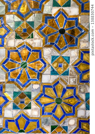 Tiny mirror pieces and gold surfaces show careful exterior work from the Rattanakosin era. The close framing reveals patient traditional craft. Tiny mirror pieces and gold surfaces show careful exterior work from the Rattanakosin era. The close framing reveals patient traditional craft. 138830744