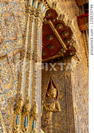 Tiny mirror pieces and gold surfaces show careful exterior work from the Rattanakosin era. The close framing reveals patient traditional craft. Tiny mirror pieces and gold surfaces show careful exterior work from the Rattanakosin era. The close framing reveals patient traditional craft. 138830746