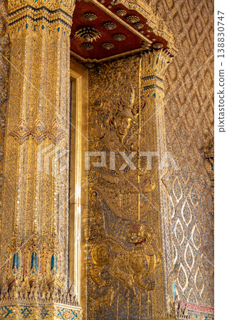 Tiny mirror pieces and gold surfaces show careful exterior work from the Rattanakosin era. The close framing reveals patient traditional craft. Tiny mirror pieces and gold surfaces show careful exterior work from the Rattanakosin era. The close framing reveals patient traditional craft. 138830747