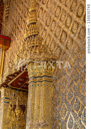 Tiny mirror pieces and gold surfaces show careful exterior work from the Rattanakosin era. The close framing reveals patient traditional craft. Tiny mirror pieces and gold surfaces show careful exterior work from the Rattanakosin era. The close framing reveals patient traditional craft. 138830748