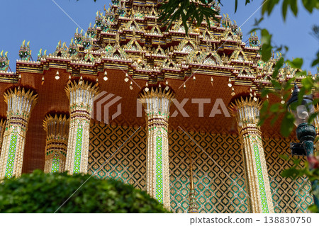 Tiny mirror pieces and gold surfaces show careful exterior work from the Rattanakosin era. The close framing reveals patient traditional craft. Tiny mirror pieces and gold surfaces show careful exterior work from the Rattanakosin era. The close framing reveals patient traditional craft. 138830750