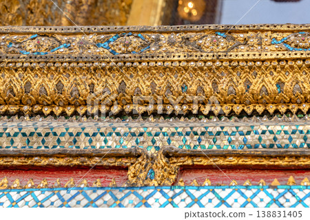 Patterned walls, frames, and roof edges create a rich study of Thai temple design. Repeated motifs and colors fill each close architectural view. Patterned walls, frames, and roof edges create a rich study of Thai temple design. Repeated motifs and colors fill each close architectural view. 138831405
