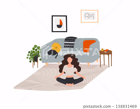 Girl sitting cross-legged in her room or apartment, practicing yoga and enjoying meditation. 138831469