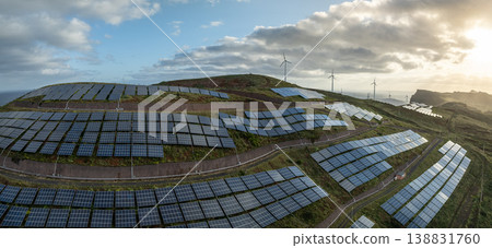 Solar energy panels photovoltaic cell and wind power plants on the seashore landscape for production of renewable green energy 138831760