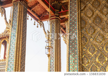 Sunlight catches mirror glass, painted surfaces, and gold edges across the temple exterior. Each close crop emphasizes texture, shine, and depth. 138831830