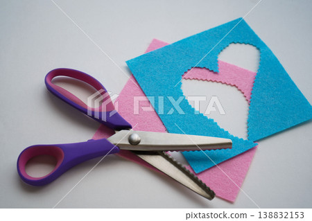 Scissors are placed on the pieces of felt. Needlework and sewing activities. Scissors are placed on the pieces of felt. Needlework and sewing activities. 138832153
