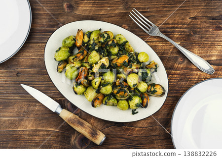 Delicious seafood, brussels sprouts dish and mussels. Delicious seafood, brussels sprouts dish and mussels. 138832226
