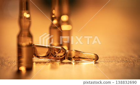 Close-up of glass vials with liquid medicine, warm bokeh lighting, laboratory concept Close-up of glass vials with liquid medicine, warm bokeh lighting, laboratory concept 138832690