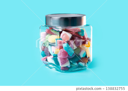Colorful assorted gummy candies in glass jar on blue background 138832755