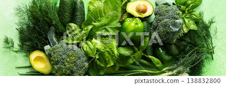 A vibrant collection of fresh green vegetables and herbs fills the scene, showcasing broccoli, cucumbers, lettuce, avocado, and various herbs like basil and dill, healthy eating, banner A vibrant collection of fresh green vegetables and herbs fills the scene, showcasing broccoli, cucumbers, lettuce, avocado, and various herbs like basil and dill, healthy eating, banner 138832800