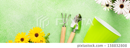 Bright spring flowers in vibrant colors decorate a balcony. Gardening tools lie next to colorful pots, inspiring a joyful planting activity on a sunny day, banner Bright spring flowers in vibrant colors decorate a balcony. Gardening tools lie next to colorful pots, inspiring a joyful planting activity on a sunny day, banner 138832808