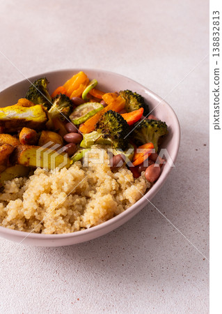 A well-balanced breakfast spread showcasing quinoa, baked sweet potato with carrots, zucchini, broccoli, beans, and baked chicken breast seasoned with turmeric 138832813
