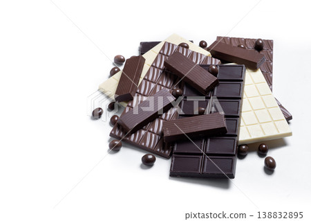 Assortment of white, milk and dark chocolate pieces isolated on white background Assortment of white, milk and dark chocolate pieces isolated on white background 138832895