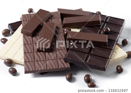 Assortment of white, milk and dark chocolate pieces isolated on white background 138832897