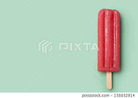 Strawberry popsicle on green background. Copy space 138832914