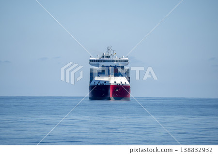 container ship on tranquil sea front view container ship on tranquil sea front view 138832932