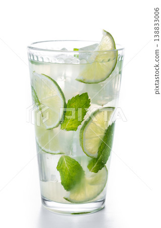 Fresh mojito cocktail with lime mint and ice in glass isolated on white background Fresh mojito cocktail with lime mint and ice in glass isolated on white background 138833006