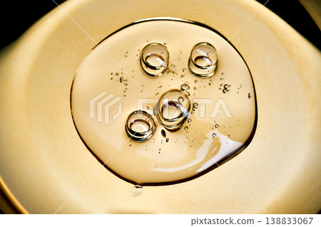 Gold liquid oil dropping with bubbles surface Gold liquid oil dropping with bubbles surface 138833067