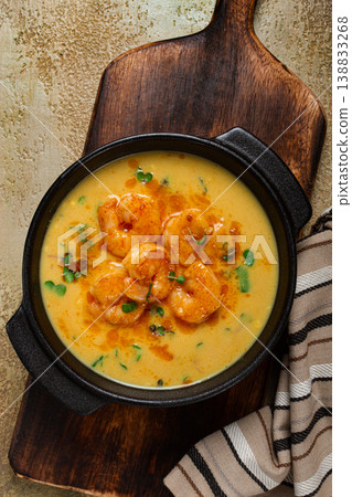 Creamy shrimp curry with spices, garnished with herbs, on a textured background, homemade , no people, Creamy shrimp curry with spices, garnished with herbs, on a textured background, homemade , no people, 138833268