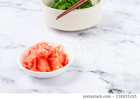 Chuka salad, made from fresh seaweed, with sesame dressing, in a white bowl, with chopsticks and pickled ginger, without people, Chuka salad, made from fresh seaweed, with sesame dressing, in a white bowl, with chopsticks and pickled ginger, without people, 138833285