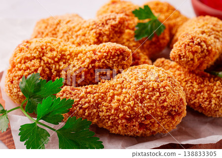 fried chicken legs in breadcrumbs, on a wooden chopping board, with red sauce, no people, fried chicken legs in breadcrumbs, on a wooden chopping board, with red sauce, no people, 138833305