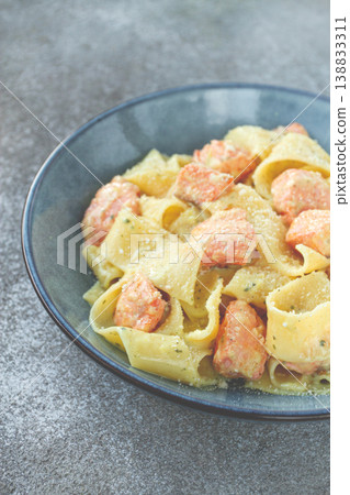 papardelle pasta, in creamy sauce with salmon, homemade, on a gray background, no people, papardelle pasta, in creamy sauce with salmon, homemade, on a gray background, no people, 138833311
