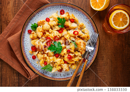 spicy fried cauliflower served on a wooden countertop, spicy fried cauliflower served on a wooden countertop, 138833330