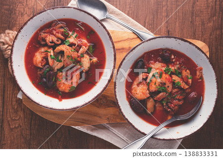 two plates of seafood in tomato sauce, olives, top view two plates of seafood in tomato sauce, olives, top view 138833331