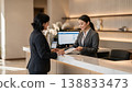Hotel Reception Check In, Guest and Receptionist at Front Desk 138833473