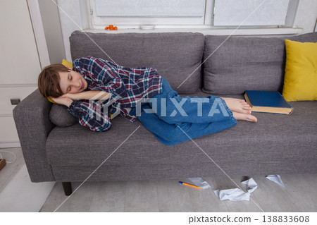Child resting peacefully on couch during afternoon Child resting peacefully on couch during afternoon 138833608