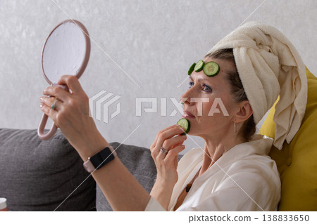 Relaxing spa day at home with cucumbers and pampering ritual in cozy living room 138833650