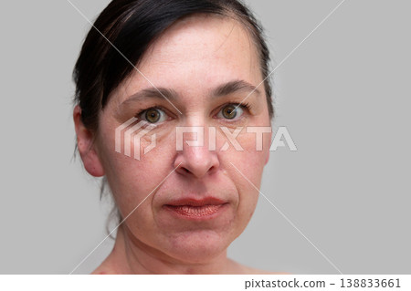 Portrait of a woman close -up with wrinkles and age -related facial changes after forty years Portrait of a woman close -up with wrinkles and age -related facial changes after forty years 138833661