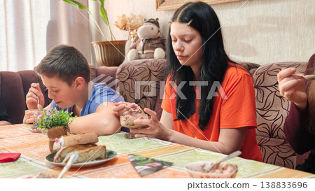 Friends enjoy dessert together at home during afternoon gathering in casual setting Friends enjoy dessert together at home during afternoon gathering in casual setting 138833696