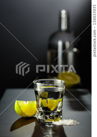 Mexican Tequila shot with lime and salt on black table. 138833935