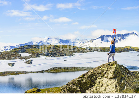 Tourist with norwegian flag in mountains Tourist with norwegian flag in mountains 138834137
